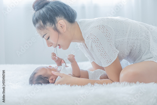 mother touches her child with tenderness and cherishness photo