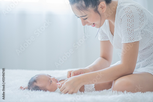 mother wearing a shirt to her child and touches her child with tenderness and cherishness photo