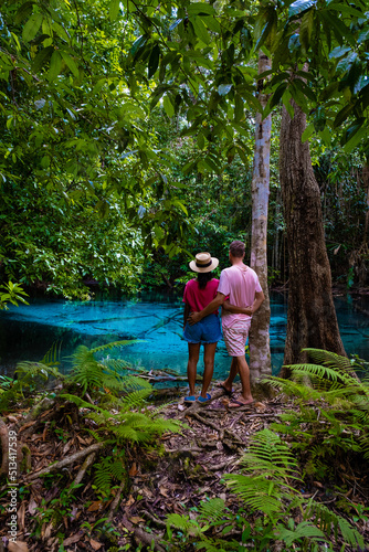 Emerald pool and Blue pool, trees, and mangroves with crystal clear water in Emerald Pool in Krabi Province, Thailand. couple men and woman visit blue pool Krabi photo