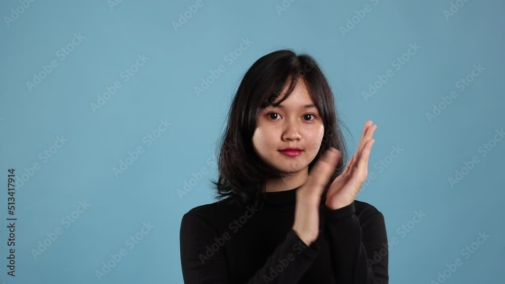 Female student giving applause isolated blue background Female student giving applause isolated blue background