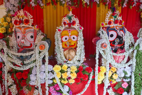 Idols of God Jagannath, Balaram and Goddess Suvadra. Lord Jagannath is being worshipped with garlands for Rath jatra festival - at Howrah, West Bengal, India. photo