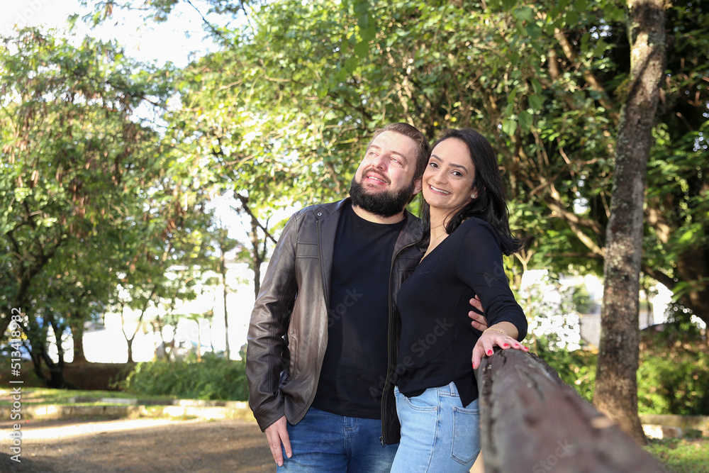 Couple Hugging at the Park. Couple at an Outdoor Park in a Summer Day. Couple Hugging at the Park. Couple at an Outdoor Park in a Summer Day.