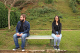 Couple Sitting on a Park Bench and Looking to Different Directions. Disagreement Relationship Concept.