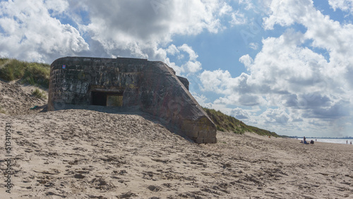 Ruin of bunker at the coast of the north sea on the beach with dune landscape near Dunkirk, Bray-Dunes, France