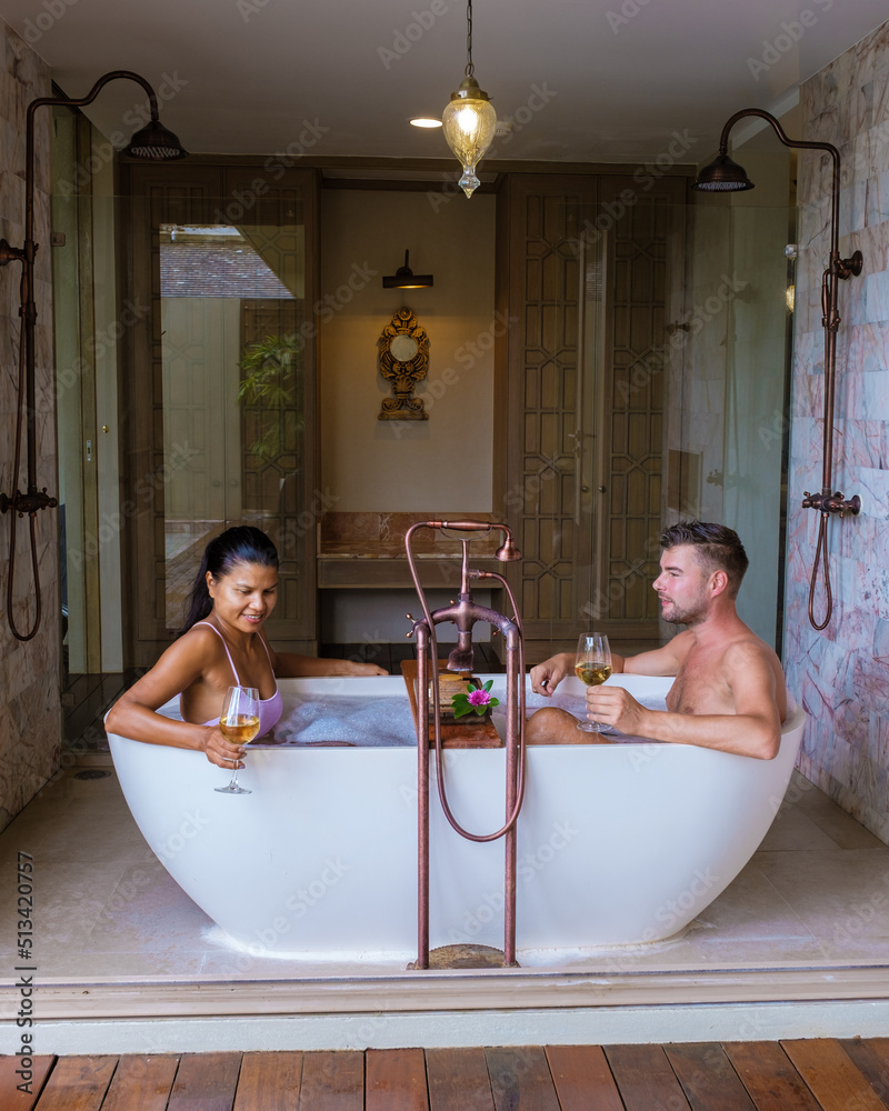 romantic bath tub with rose petals, luxury vacation in jacuzzi, couple ...