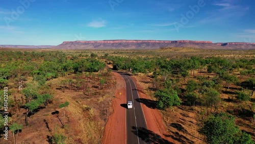 Aerial push in video of a camper van traveling across beautiful El Questro, Kimberley, Kununurra, Western Australia photo