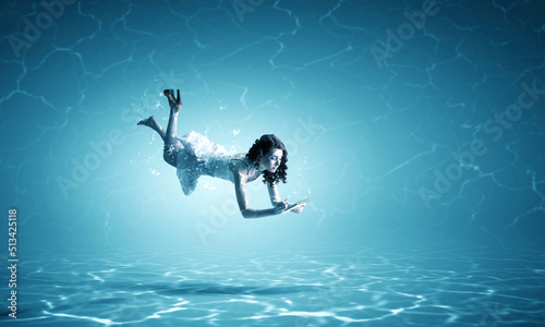 Woman holding a cup underwater