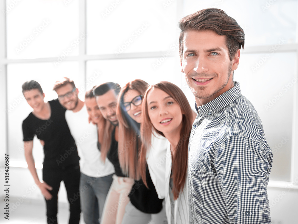 group of successful young people standing in the office