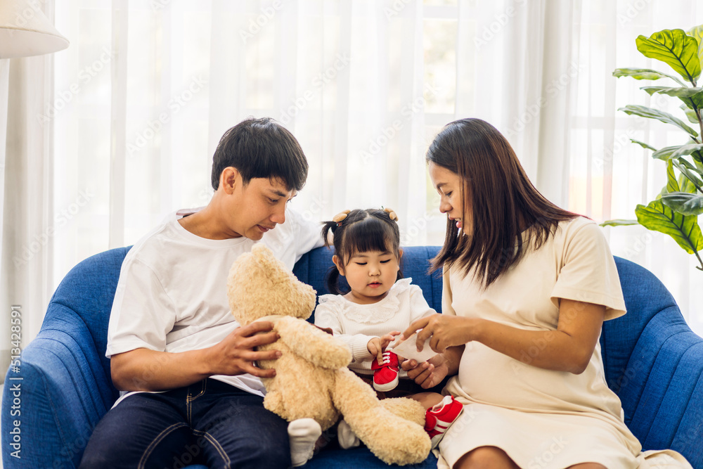Portrait of enjoy happy love asian family father and mother holding hug cute little asian girl child smiling play and having fun moments good time at home Portrait of enjoy happy love asian family father and mother holding hug cute little asian girl child smiling play and having fun moments good time at home