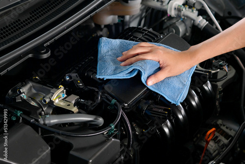 hand of a man holding a blue cloth caring, maintenance car and cleaning And engine car room