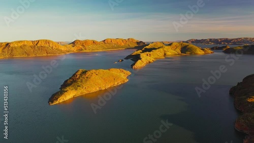 Aerial pushing in video of beautiful sunset and crocodile rock in Lake Argyle, Kimberley, Westerm Australia	 photo