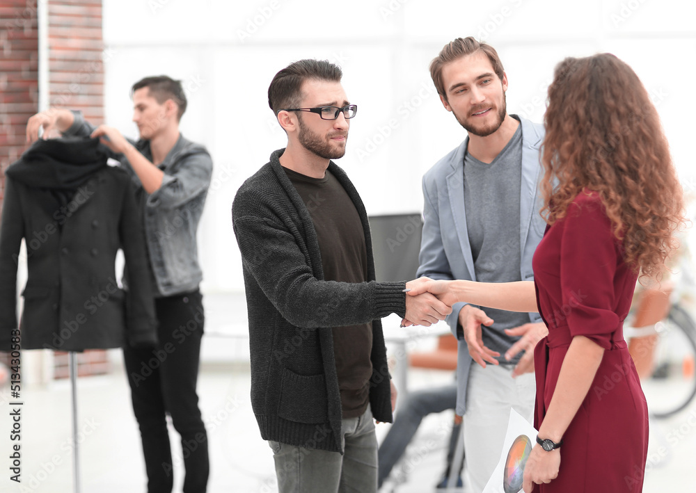 designer shaking hands with a business woman designer shaking hands with a business woman