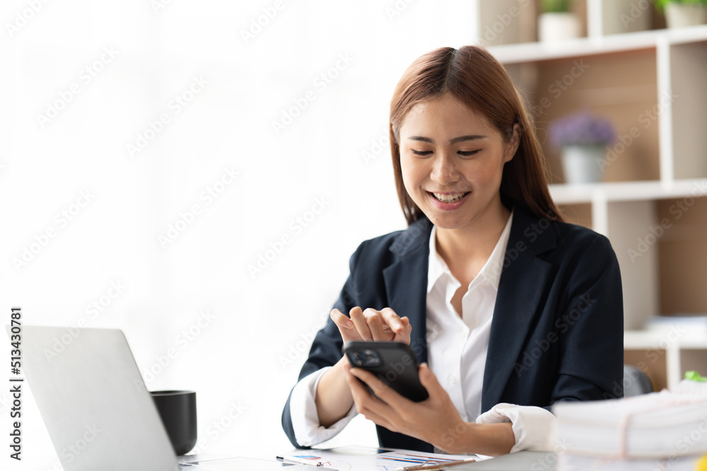 Asian businesswoman in formal suit in office happy and cheerful during using smartphone and working, copy space. Asian businesswoman in formal suit in office happy and cheerful during using smartphone and working, copy space.