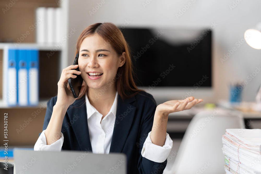 Asian businesswoman in formal suit in office happy and cheerful during using smartphone and working, copy space. Asian businesswoman in formal suit in office happy and cheerful during using smartphone and working, copy space.