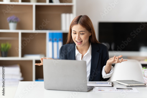 Young attractive business asian woman talking about sale report in video call conference on notebook computer online meeting in working from home.