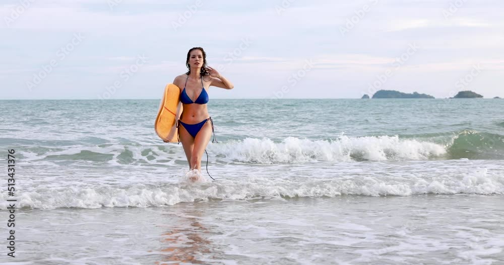 Young Asian women wearing bikini playing relaxing with surfboard enjoying summer vacation, 4k video Young Asian women wearing bikini playing relaxing with surfboard enjoying summer vacation, 4k video