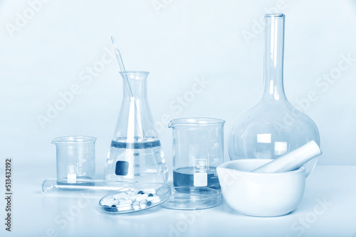 Pills and scientific laboratory glassware, Medicine research and development concept, Pharmaceutical quality control test.