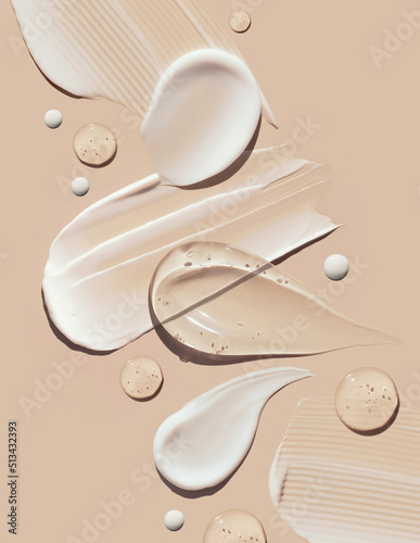cosmetic smears of creamy texture on a pastel beige background	
