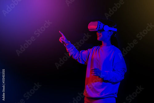 Teenager having fun play VR virtual reality glasses  on  background.  © CK