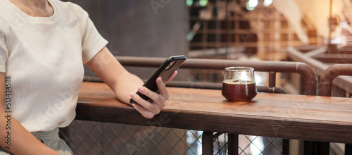 Casual Businesswoman holding and using smartphone for sms messages, young woman typing touchscreen mobile phone in coffee cafe or modern office. lifestyle, technology, Social media and network concept