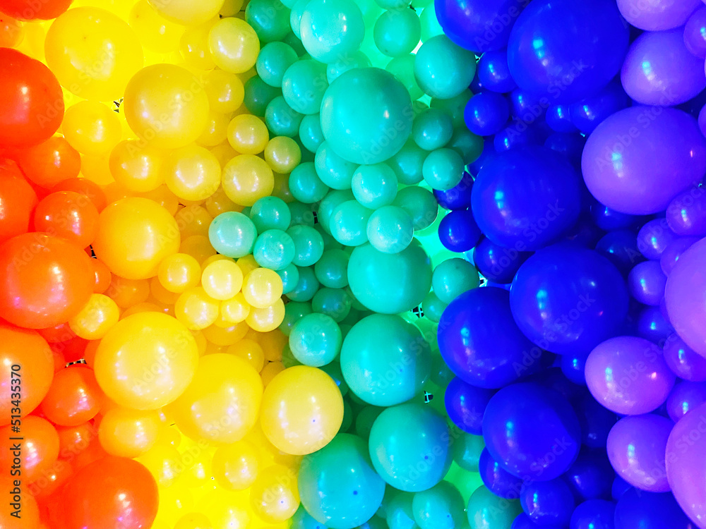 Fototapeta premium Bright abstract background of jumble of rainbow colored balloons celebrating