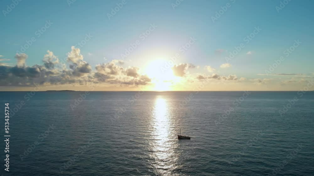 Aerial Drone Shot Of Peaceful Sunset Flying Above Calm Sea Surface Waves And Ripples With Boats Floating On The Water In Vilanculos Bazaruto Archipelago, Mozambique, Africa. Aerial Drone Shot Of Peaceful Sunset Flying Above Calm Sea Surface Waves And Ripples With Boats Floating On The Water In Vilanculos Bazaruto Archipelago, Mozambique, Africa.