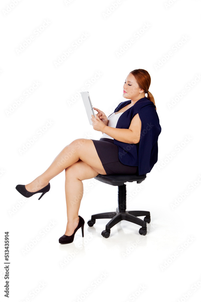 Fat businesswoman using a tablet on studio Fat businesswoman using a tablet on studio