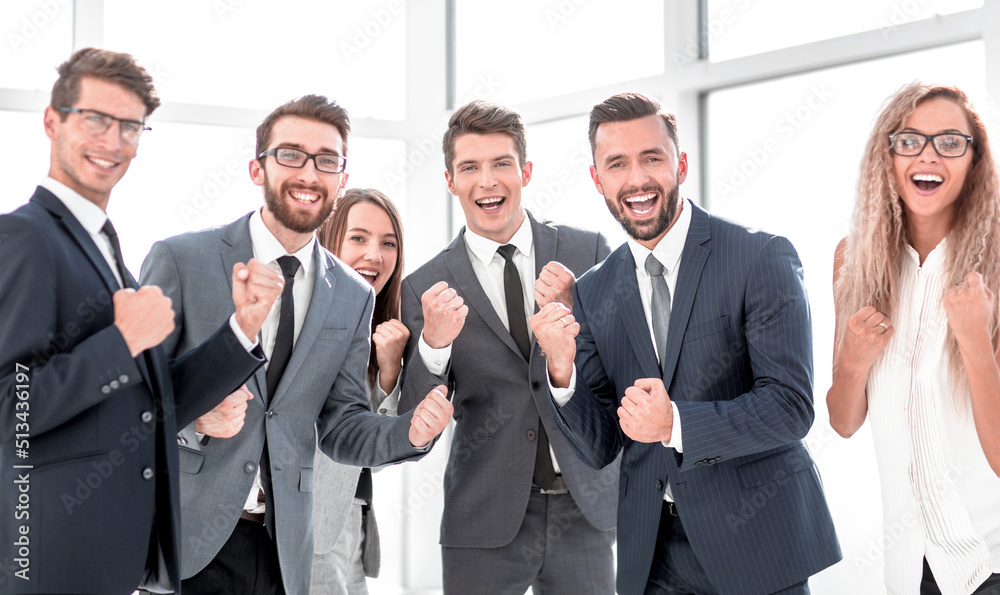 happy business team standing in office. happy business team standing in office.
