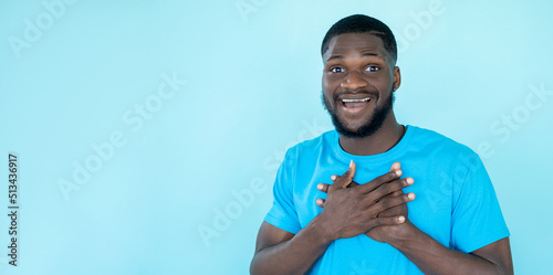 Thankful man. Grateful gesture. Express gratitude. Surprised impressed happy touched guy isolated on blue copy space banner background.