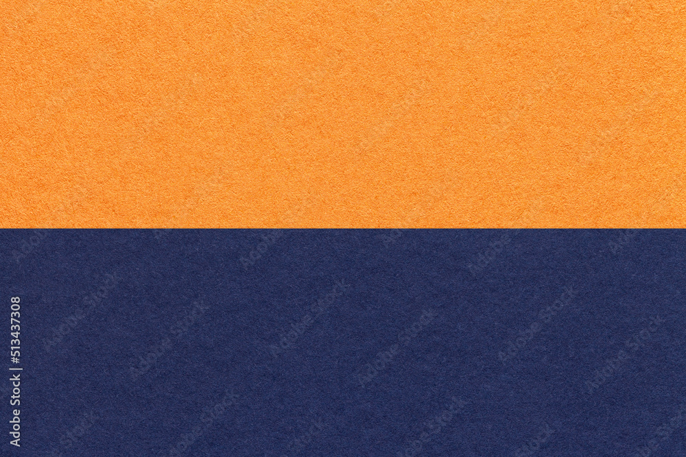Texture of craft orange and navy blue paper background, half two colors, macro. Structure of vintage dense cardboard Texture of craft orange and navy blue paper background, half two colors, macro. Structure of vintage dense cardboard