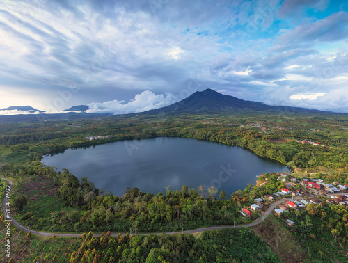 A lake with a mountain background arround the cinnamon plantation in the centre of sumatra highland