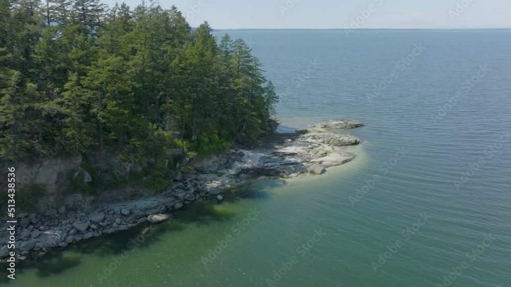 Aerial pan of a tiny island in Puget Sound near Bellingham, Washington.