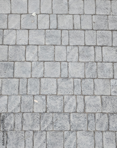 Granite cobblestone background. Paving stone texture. Pavement.
