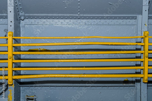 Exposed metal hydraulic lines secured to aircraft bulkheads in military cargo plane.