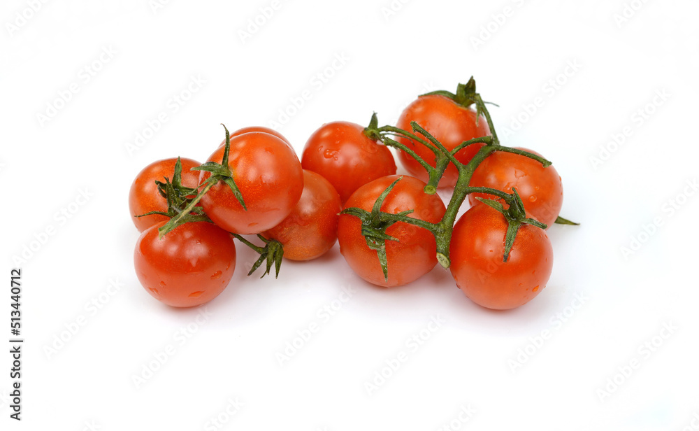Bunch of fresh, red tomatoes with green stems isolated on white background. Clipping path. Bunch of fresh, red tomatoes with green stems isolated on white background. Clipping path.