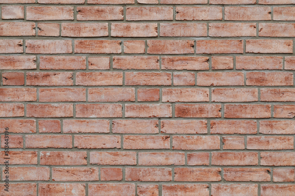 Beautiful red brick wall with red stones. Bricklayer as a background with space for text. No person Beautiful red brick wall with red stones. Bricklayer as a background with space for text. No person