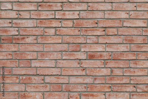 Beautiful red brick wall with red stones. Bricklayer as a background with space for text. No person 