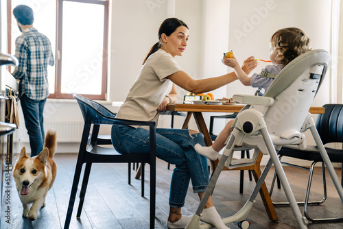 Happy young fmaily having breakfast in the kitchen photo