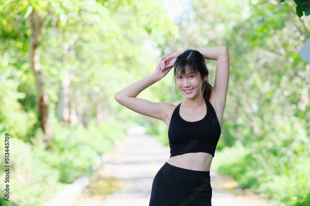 Woman doing exercise in the park. young woman works out her muscles against a natural backdrop. jogger on a nature trail working on their cardio fitness Woman doing exercise in the park. young woman works out her muscles against a natural backdrop. jogger on a nature trail working on their cardio fitness