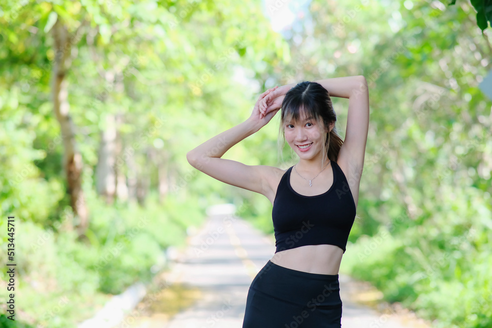 Woman doing exercise in the park. young woman works out her muscles against a natural backdrop. jogger on a nature trail working on their cardio fitness Woman doing exercise in the park. young woman works out her muscles against a natural backdrop. jogger on a nature trail working on their cardio fitness