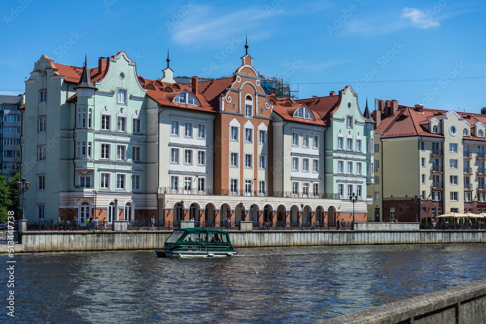 Beautiful old houses by the river. Fishing village on a summer day. Kaliningrad (until 1946 - Konigsberg). Fishing village in Kaliningrad.