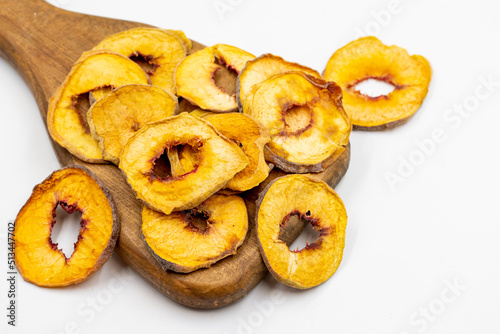 Dried peach slices. Sliced dry peach isolated on white background. Sun-dried fruit. Close up © enezselvi