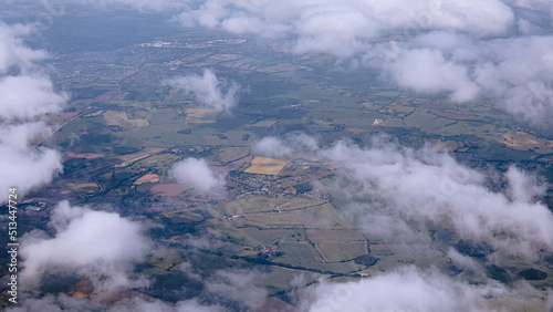 Aerial view of farms and fields with white fluffy clouds