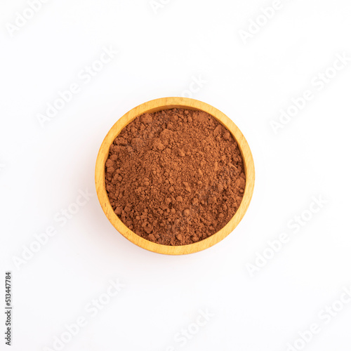 Cocoa powder or chocolate powder in wooden bowl  isolated on white background