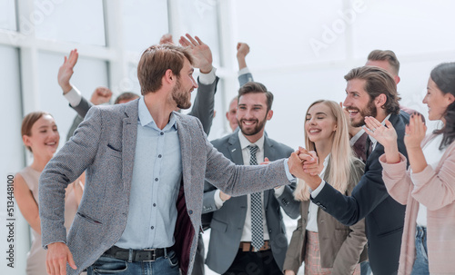 corporate group of employees congratulating their colleague.