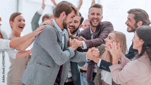 corporate group of employees applauding their colleague.