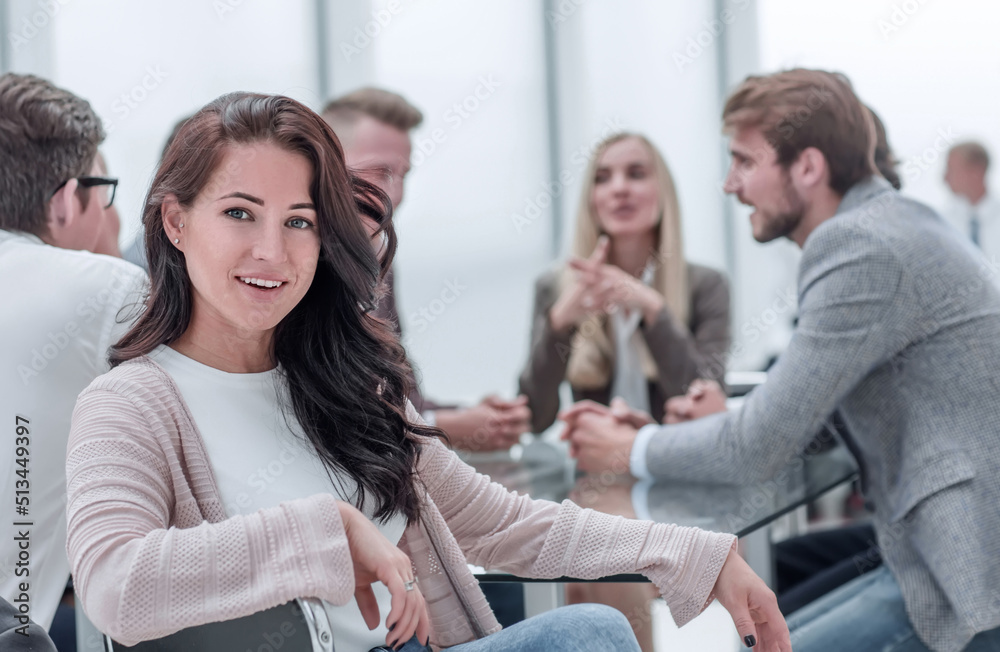 successful business woman sitting in front of a table in a conference room.