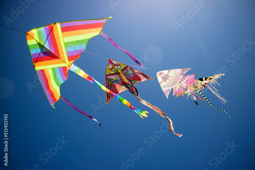 Series of colorful kites flying in the blue sky
