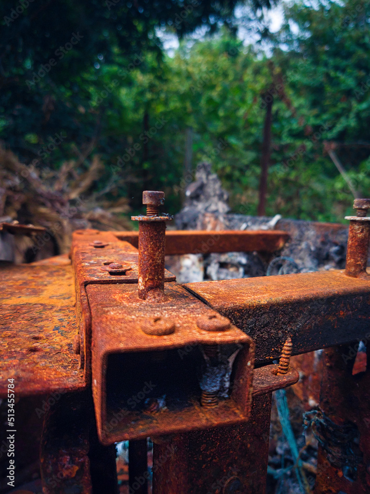 Close up of a rusted and burnt screw on a massage chair