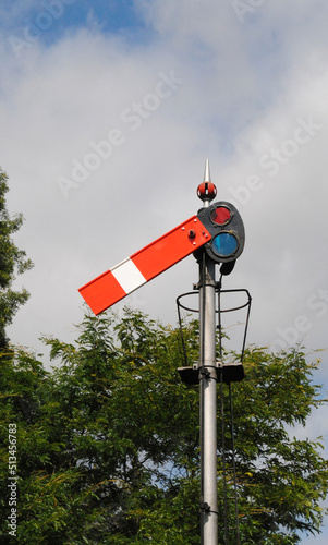 Close Up of Old Railway Signal against Cloudy Blue Sky 